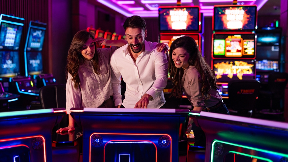 Three,Friends,Having,Fun,In,A,Vibrant,Casino,,Playing,Slot
